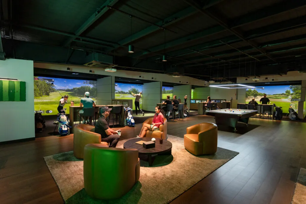 Wide view of the GolfSpace floor with bays, lounge and pool table