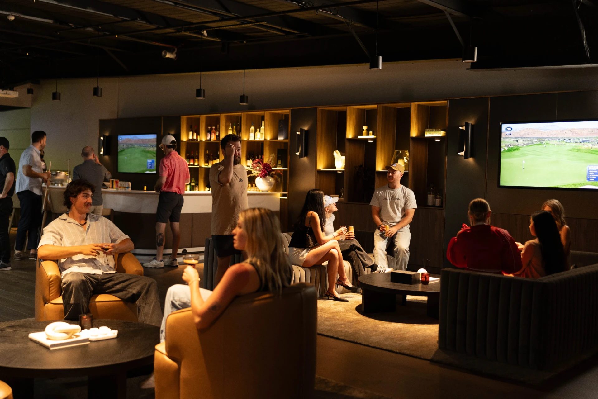 Guests gathered in the GolfSpace lounge and whisky bar at night